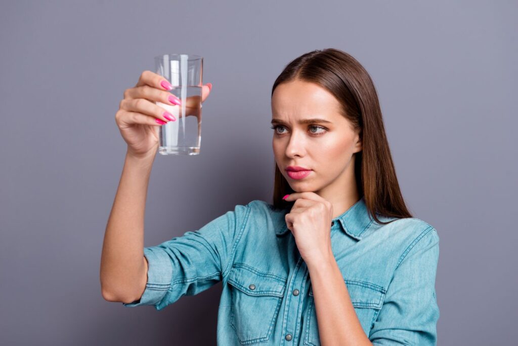 A woman looking into a glass of water